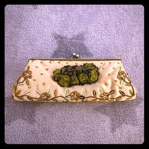 Golden evening purse with metallic hardware